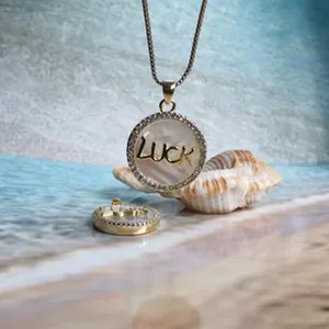 Detailed view of stainless steel gold plated crystal shell round necklace pendant jewelry item.