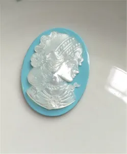 Natural mother of pearl shell cameo pendant detail, carved vintage woman portrait jewelry part.