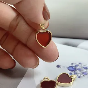Elegant natural red agate heart pendant necklace accessory with gold frame, minimalist style.