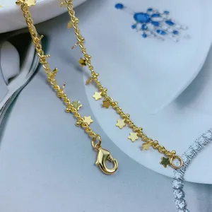Gold star chain necklace detail shot, minimalist clavicle chain accessory without pendant.