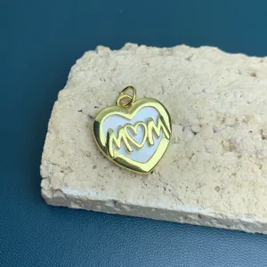 Detail shot of a gold heart MOM pendant, elegant jewelry accessory for Mother's Day gift.