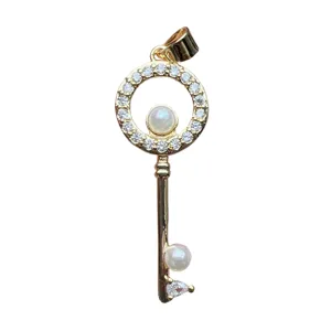 Gold key pendant with sparkling cubic zirconia and elegant pearls for DIY jewelry making.