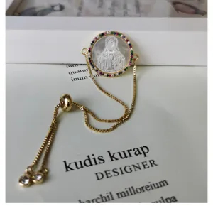 Gold mother-of-pearl pendant bracelet accessory with colorful zirconia and adjustable chain.