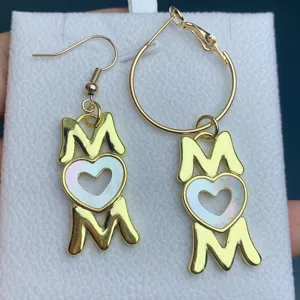 Gold MOM heart pendant earrings detailed view, perfect fashion mother's day jewelry gift.