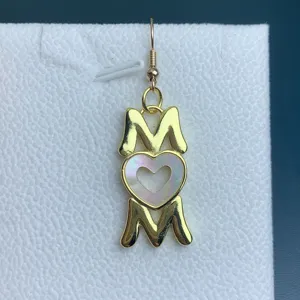 Gold MOM heart earring detail shot, exquisite mother of pearl charm pendant accessory.
