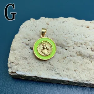 Close-up of gold-plated green enamel Maria pendant detail, exquisite religious jewelry accessory.