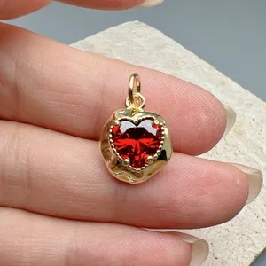 Red heart zircon pendant detail, shiny gold irregular bezel, ideal for DIY necklace jewelry.