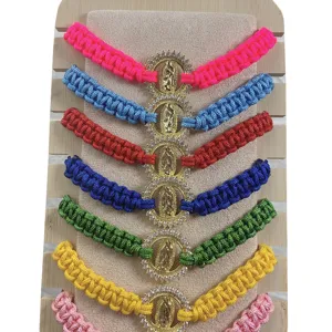 Colorful woven rope bracelet set featuring a gold rhinestone Guadalupe virgin pendant.