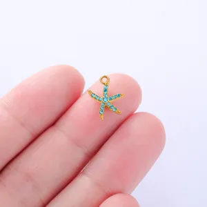 Close-up detail of a golden starfish pendant sparkling with blue rhinestones for DIY crafts.