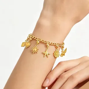 Gold charm bracelet detail featuring cute starfish sun and daisy pendants for DIY jewelry making.