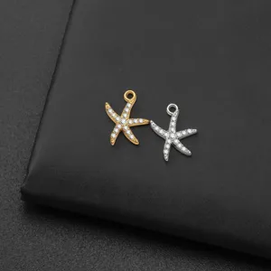 Detailed close-up of gold and silver starfish pendant charms, sparkling crystal paved jewelry.