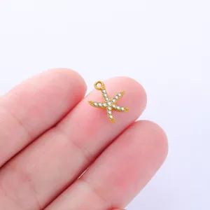 Detailed shot of gold-plated starfish charm with sparkling rhinestones for DIY jewelry making.