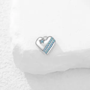 Vista detallada de un colgante de corazon de plata con circonitas azules muy brillantes.