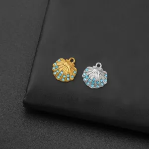 Close up view of gold and silver shell pendants with blue rhinestones for DIY jewelry.