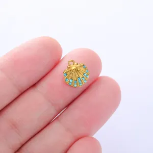 Gold shell pendant detail with blue rhinestones for DIY jewelry making accessories.