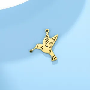 Detailed shot of gold hummingbird double-hole pendant, smooth metal finish for DIY jewelry.