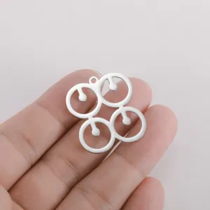 Stainless steel geometric symbol pendant detail showing the unique four-ring metal structure.