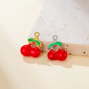 Detailed shot of cute cherry charms in gold and silver, perfect for DIY jewelry making.