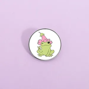 Close-up detail of a cute frog metal brooch pin featuring a charming cartoon design.