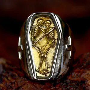 Close-up detail of gothic retro coffin ring featuring dual skeleton design and cross accents.