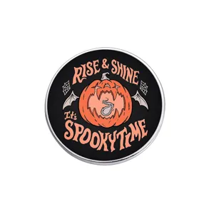 Dark style Halloween pumpkin brooch detail shot, metal round pin with spooky orange design.