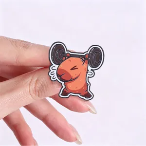 Close-up detail of the cute fitness capybara metal brooch pin, showing fine craftsmanship.