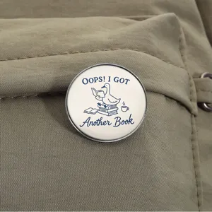 Close-up detail of a cute reading duck metal pin badge attached on canvas backpack.