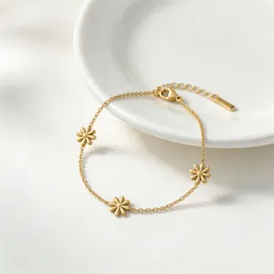 Gold plated titanium steel floral daisy bracelet detail view, elegant minimalist jewelry accessory.