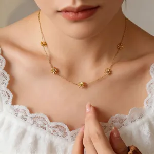 Delicate gold-plated daisy flower station necklace close-up, elegant clavicle chain jewelry.