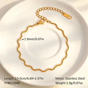 Detailed shot of stainless steel wavy chain necklace bracelet set in gold finish specs.
