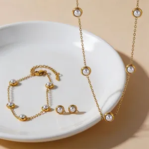 Minimalist titanium steel pearl necklace bracelet and earrings set with elegant gold finish.