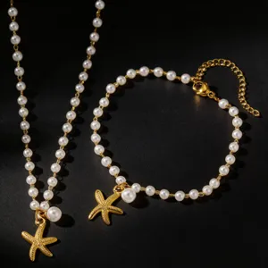Pearl starfish necklace bracelet set, beach vacation jewelry, elegant gold tone design.