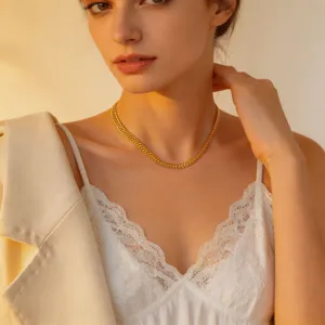 Elegant gold herringbone clavicle necklace detail shot, versatile fashion jewelry piece.
