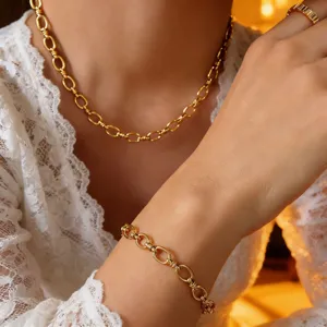 Elegant gold link chain necklace and bracelet set featuring modern interlocking link design.