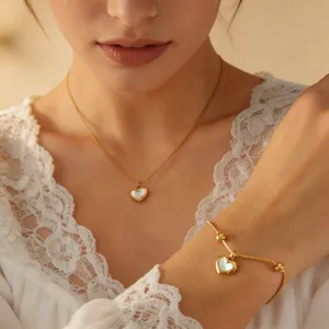 White mother-of-pearl heart pendant necklace bracelet set, elegant gold fashion jewelry for women.