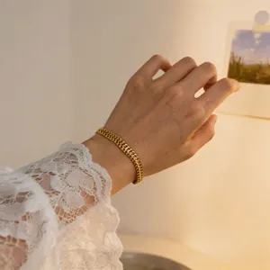 Elegant gold wheat chain bracelet detail view, minimalist stainless steel wrist jewelry for women.