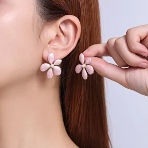 Elegant pink flower stud earrings with pearl center, delicate floral jewelry for daily wear.