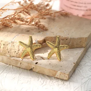Gold stainless steel starfish earrings detail close-up, retro niche fashion jewelry.