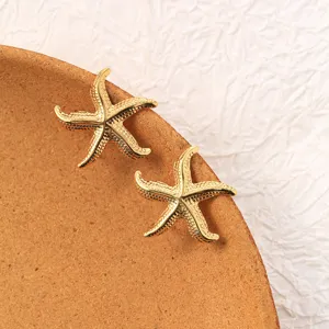 Golden starfish stud earrings detail view, vintage stainless steel jewelry accessory showcase.