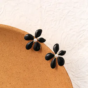 Chic black flower stud earrings with pearl center, elegant metal daily detail shot.