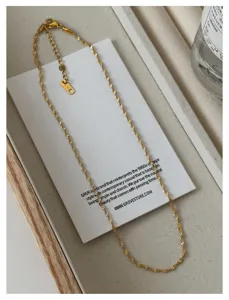 Detailed close-up of 18K gold plated stainless steel twist chain necklace with elegant design.
