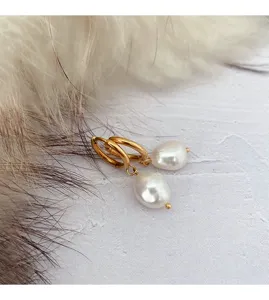Detail close-up of French stainless steel irregular pearl hoop earrings, elegant minimalist design.