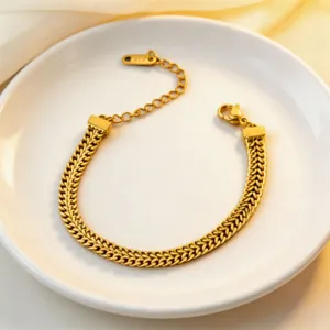 Elegant gold-tone herringbone chain bracelet detailed with delicate extension and lobster clasp.