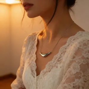 Detailed shot of a sleek minimalist geometric irregular arc pendant necklace in titanium steel.