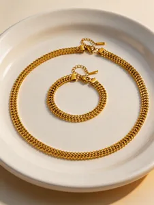 Gold titanium steel braided chain necklace and bracelet set close-up detail.