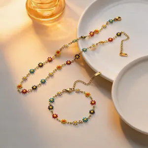 Detailed view of colorful enamel daisy flower titanium steel necklace and bracelet set.
