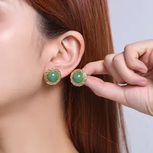 Close-up detail shot of vintage 18k gold plated green stone stainless steel stud earrings