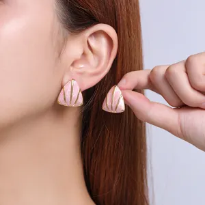 Pink geometric triangle enamel stud earrings, stylish minimalist titanium steel jewelry detail.