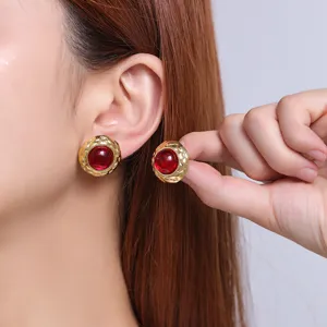 Detail close-up of 18K gold plated stainless steel vintage red stone stud earrings.