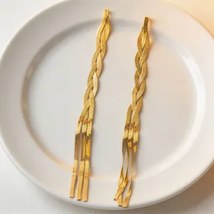 Detailed view of long gold snake bone chain necklace, minimalist style stainless steel jewelry.